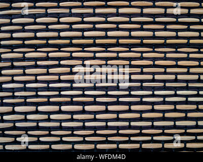 Bamboo woven with black fabric, textured surface Stock Photo