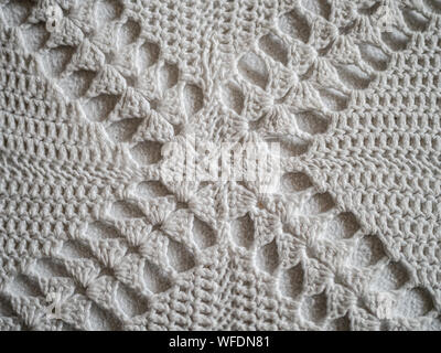 Close up of white crocheted fabric pattern in a cross Stock Photo