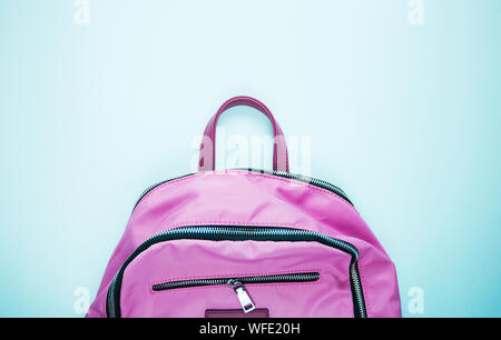 Bright pink school backpack on bright background, space or text flat layer. Concept back to school. Close-up, copy space, flat lay. Stock Photo