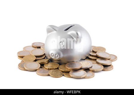 Silver piggy bank with euro coins on white background Stock Photo