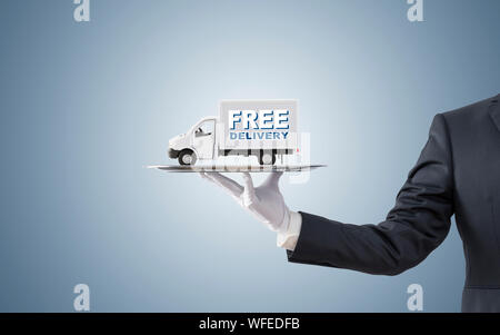 Businessman offering free delivery on silver tray Stock Photo