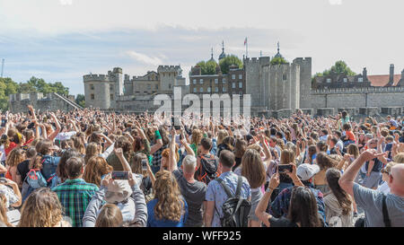 London, UK. 31st Aug, 2019. Queens from SiX the Musical and their Queendom of fans participate in a Flashmob at the Tower of London. Stars adn fans of The smash-hit musical about the six wives of Henry VIII, with music and lyrics by Toby Marlow and Lucy Moss and choreography by Carrie-Anne Ingrouille assembled in front of the Tower of London to perform a choreographed dance to the shows finale song 'One of a Kind' Credit: amanda rose/Alamy Live News Stock Photo