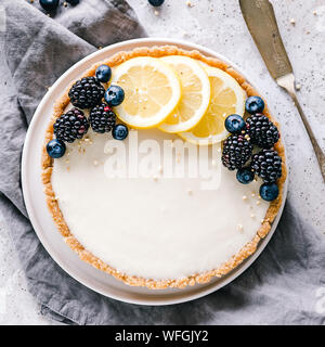 No bake Lemon tart with lemon slices, blueberries and blackberries Stock Photo