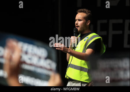 Organiser Michael Chessum addressing protesters taking part in the 'Let Us Vote' day of action, organised by Another Europe is Possible campaign group in central London to demonstrate against Prime Minister Boris Johnson's decision to suspend Parliament for up to five weeks before a Queen's Speech on October 14. Stock Photo