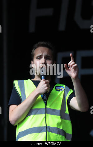 Organiser Michael Chessum addressing protesters taking part in the 'Let Us Vote' day of action, organised by Another Europe is Possible campaign group in central London to demonstrate against Prime Minister Boris Johnson's decision to suspend Parliament for up to five weeks before a Queen's Speech on October 14. Stock Photo