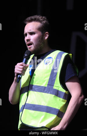 Organiser Michael Chessum addressing protesters taking part in the 'Let Us Vote' day of action, organised by Another Europe is Possible campaign group in central London to demonstrate against Prime Minister Boris Johnson's decision to suspend Parliament for up to five weeks before a Queen's Speech on October 14. Stock Photo