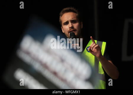 Organiser Michael Chessum addressing protesters taking part in the 'Let Us Vote' day of action, organised by Another Europe is Possible campaign group in central London to demonstrate against Prime Minister Boris Johnson's decision to suspend Parliament for up to five weeks before a Queen's Speech on October 14. Stock Photo