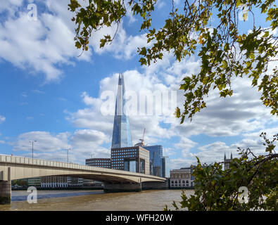 View from Thames Path on the North Bank of London Bridge looking south over the River Thames to the Shard and the South Bank in Southwark, London SE1 Stock Photo