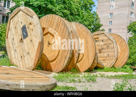 Large empty wooden coil. The new cable drum at the industrial area.  Outdoors Stock Photo