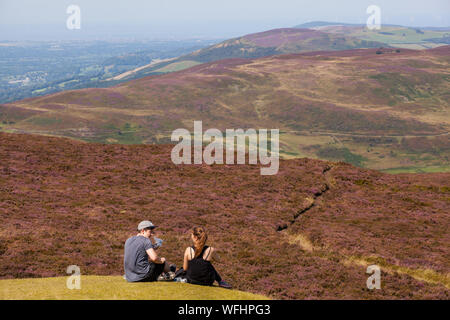 Men women children and families in the Clwydian Hills North Wales on the summit of Moel Famau  mountain Stock Photo