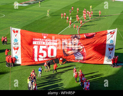 Sydney Football Club team players running through banner congratulating Dane Rampe on playing 150 AFL games, SCG Sydney NSW Australia Stock Photo
