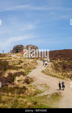 Men women children and families walking Offas Dyke footpath in the Clwydian Hills near the Jubliee Tower on the summit of Moel Famau  mountain Wales Stock Photo