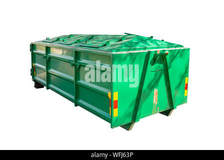 A large, metal, green garbage container and municipal waste, standing on a  dirt road near the fence and trees Stock Photo - Alamy