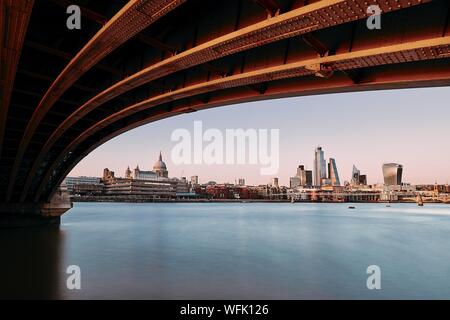 Urban skyline of London. Thames river against St. Paul's Cathedral and skyscrapes at sunset. Stock Photo
