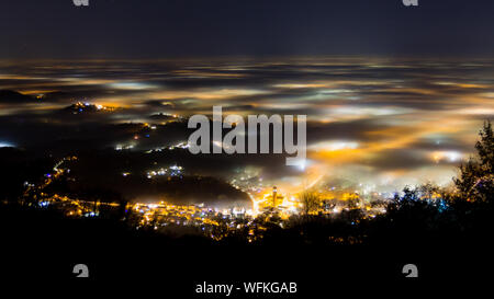 Plain illuminated partially covered by fog, soft lights.  Mount Grappa, Italian landscape Stock Photo