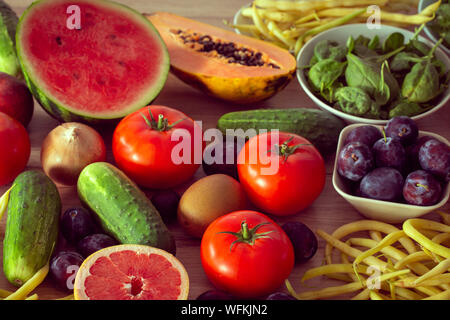 healthy diet, kitchen table full of fruits and vegetables Stock Photo