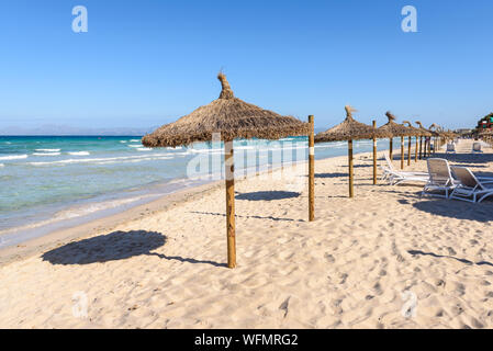 Umbrellas at the Playa de Muro beach in Mallorca, Spain Stock Photo