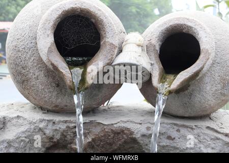 Water Pouring From Clay Made Rusty Pot Stock Photo
