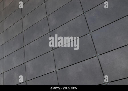 Diagonal view of smooth gray rectangular tile on wall, for background or design Stock Photo