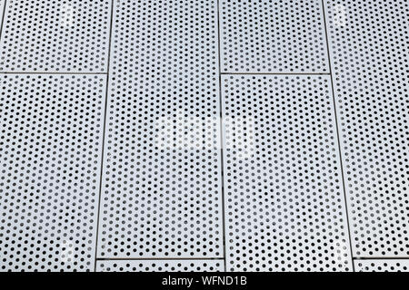 Metal grilles with many round holes in the ceiling. Dot pattern on surface. Stock Photo