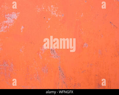 Orange painted cement wall with scratches and stains. Abstract grunge texture background. Copy space, empty template for text Stock Photo