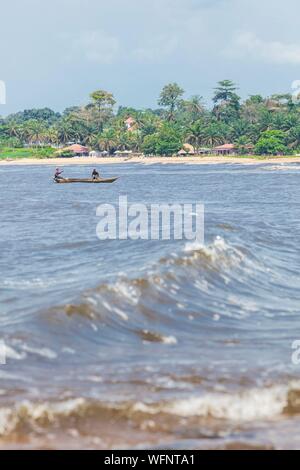 Cameroon, South Region, Ocean Department, Kribi, fishing village and canoe among waves Stock Photo