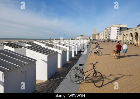 Belgium, West Flanders, Ostend, waterfront promenade, white beach cabins lined up on the sand Stock Photo
