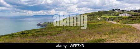 Ireland, Fingal County, northern Dublin suburbs, Howth, cliff hiking trails, hikers, in the background, the Baily lighthouse Stock Photo