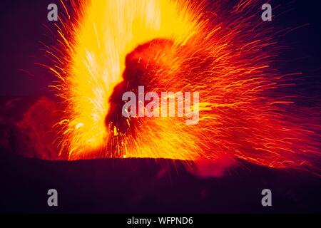 Italy, Sicily, Eolian Islands, Tyrrhenian sea, San Vincenzo, summit of Stromboli volcano 924 m, eruption of lava and projection of volcanic bombs from the central craters Stock Photo