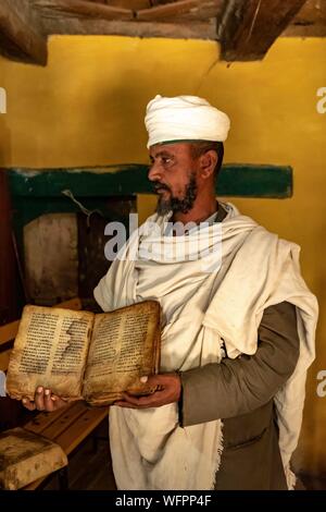 Ethiopia, Tigray regional state, Yeha temple, priest showing a holy book several hundred years old Stock Photo