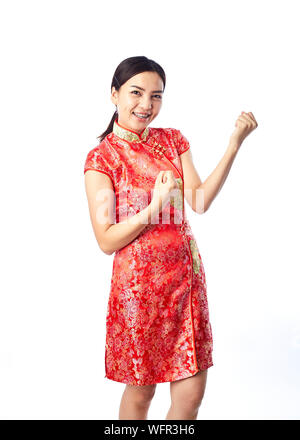Portrait Of Smiling Young Woman Wearing Red Traditional Clothing While Standing Against White Background