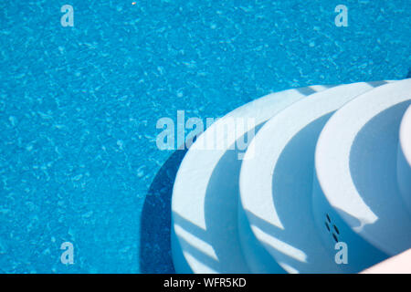 Underwater floor and white stairs into a private pool in the heat Stock Photo