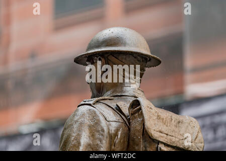 The bronze statue of a world war one soldier stands in the rain in Martin Place in Sydney, Australia at the Cenotaph memorial to World War One Stock Photo