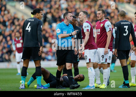 Burnley, UK. 31st Aug, 2019. 31st August 2019; Turf Moor, Burnley, Lanchashire, England; English Premier League Football, Burnley versus Liverpool; Referee Chris Kavanagh has words with Ashley Barnes and Chris Wood of Burnley after a foul on Joel Matip of Liverpool - Strictly Editorial Use Only. No use with unauthorized audio, video, data, fixture lists, club/league logos or 'live' services. Online in-match use limited to 120 images, no video emulation. No use in betting, games or single club/league/player publications Credit: Action Plus Sports Images/Alamy Live News Stock Photo