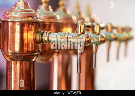 Shiny beer tap ready to serve cold beer at the bar . Stock Photo