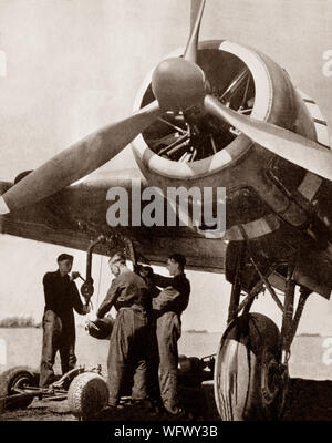 Bombs being loaded onto a Handley Page HP.52 Hampden,  a British twin-engine medium bomber of the Royal Air Force, often referred to by aircrews as the 'Flying Suitcase' because of its cramped crew conditions. It served in the early stages of the Second World War, bearing the brunt of the early bombing war over Europe, taking part in the first night raid on Berlin and the first 1,000-bomber raid on Cologne. It was retired from RAF Bomber Command service in late 1942, superseded by the larger four-engined heavy bomberslike the Avro Lancaster. Stock Photo