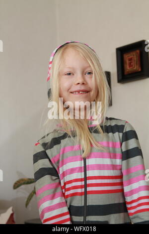 Close-up Portrait Of Girl Wearing Hooded Shirt While Standing At Home