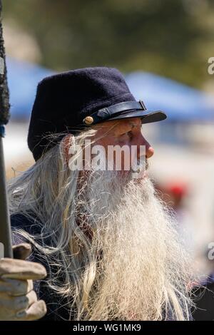 Portrait of a man with a long white beard is dressed as a union soldier during an American Civil War reenactment Stock Photo