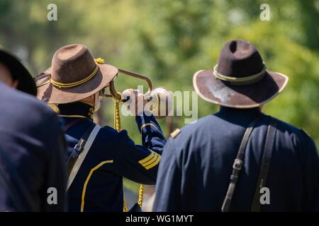 A man plays the trumpet at the end of a battle during an American Civil War reenactment Stock Photo