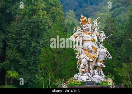 Ancient statue of fighting Kumbhakarna Rakshasa from epic Hindu legend Ramayana in Bedugul botanical garden. Traditional arts, culture of Bali Stock Photo