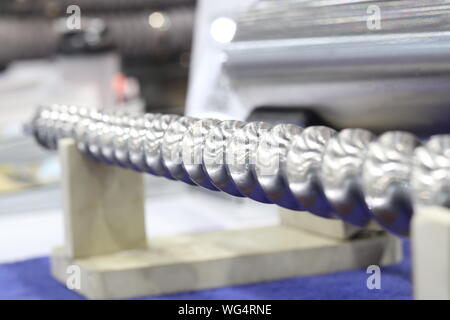 Screw press parts for plastic injection machine ; selective focus Stock Photo