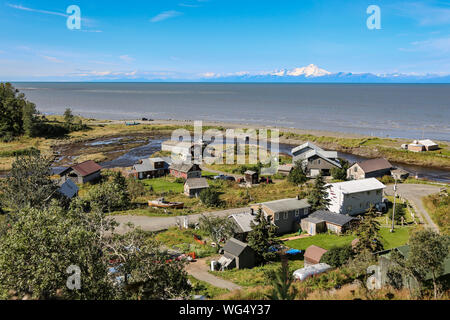 Aerial view of Ninilchik a small Alaskan Native village with Cook Inlet and Aleutian volcanoes in the background, Kenai Peninsula, Alaska Stock Photo