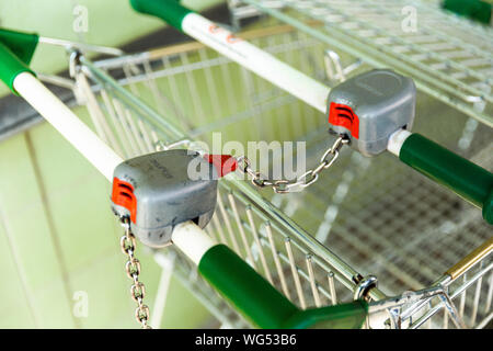 Shopping trolley carts locked together to prevent theft. Stock Photo