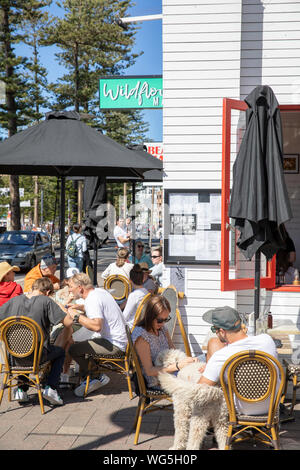 Australian cafe restaurant Hemingways in Manly beach Sydney with people enjoying coffee and breakfast lunch,Sydney,Australia Stock Photo