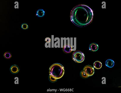 Soap bubbles on a dark background in motion. Stock Photo