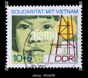 Stamp printed in GDR dedicated to solidarity with Vietnam, circa 1973. Stock Photo