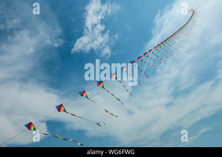 Low Angle View Of Multi Colored Kites Against Sky