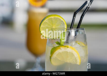 Mojito cocktail with lime and mint in a glass. Freshness cocktail, close up Stock Photo