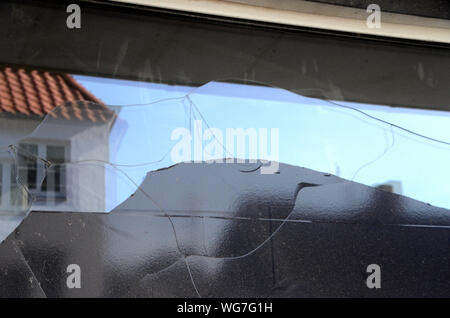 Thermal fracture in a shop window, due to coverage with black plastic foil that has caused overheating of the glas. Vandalism would have shown impact Stock Photo