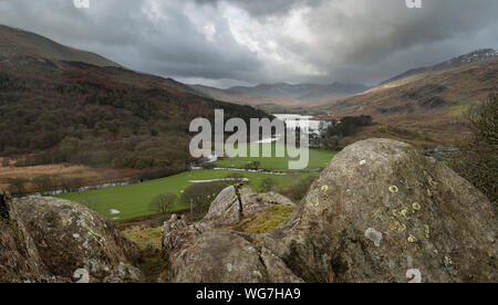 Winter landscape image of the view from Crimpiau and The Pinnacles towards Llynnau Mymbyr and snowcapped Snowdon in the distance Stock Photo